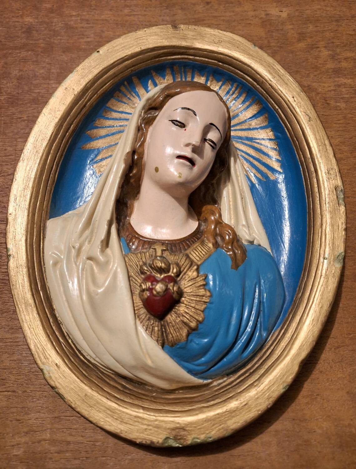 Vintage plaster frame of the Virgin, old religious painting