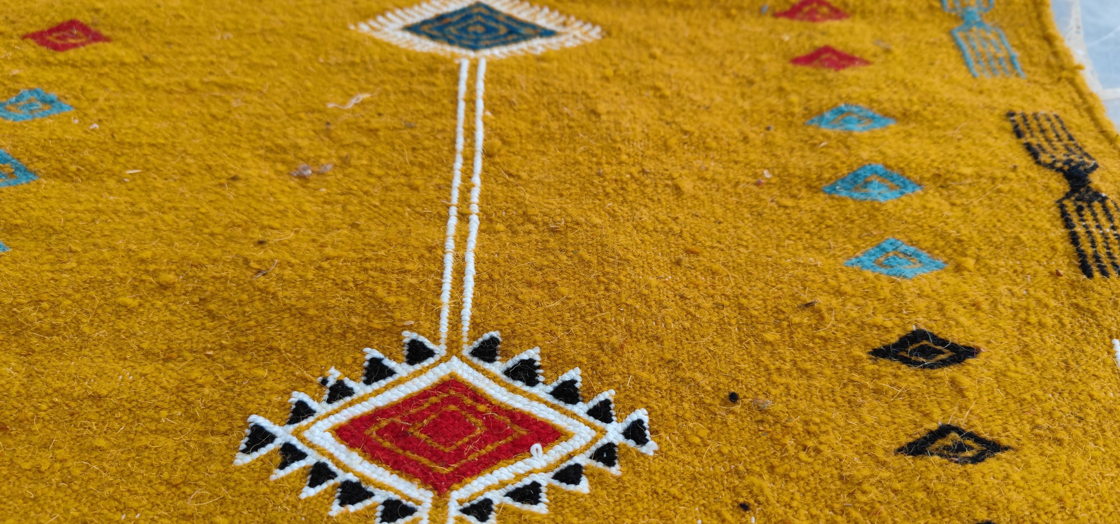Mustard yellow kilim carpet with multicolored berber patterns