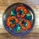 Enamelled sandstone plate with floral decoration