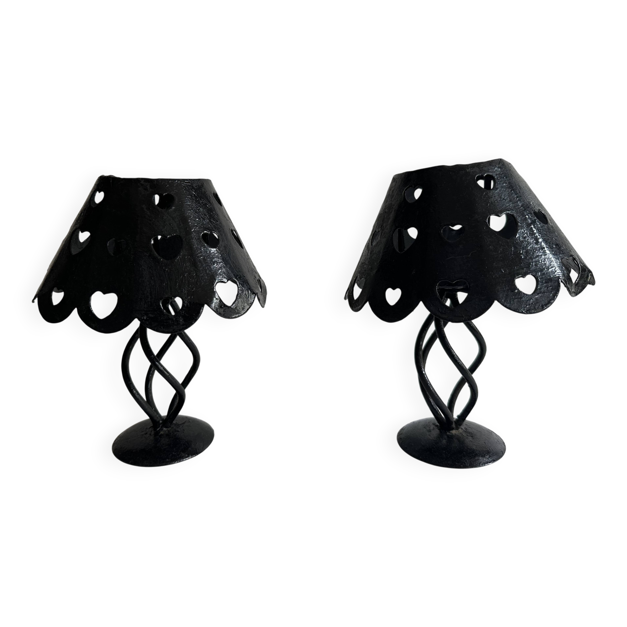 Pair of black wrought iron lanterns with heart patterns, romantic style.