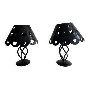 Pair of black wrought iron lanterns with heart patterns, romantic style.