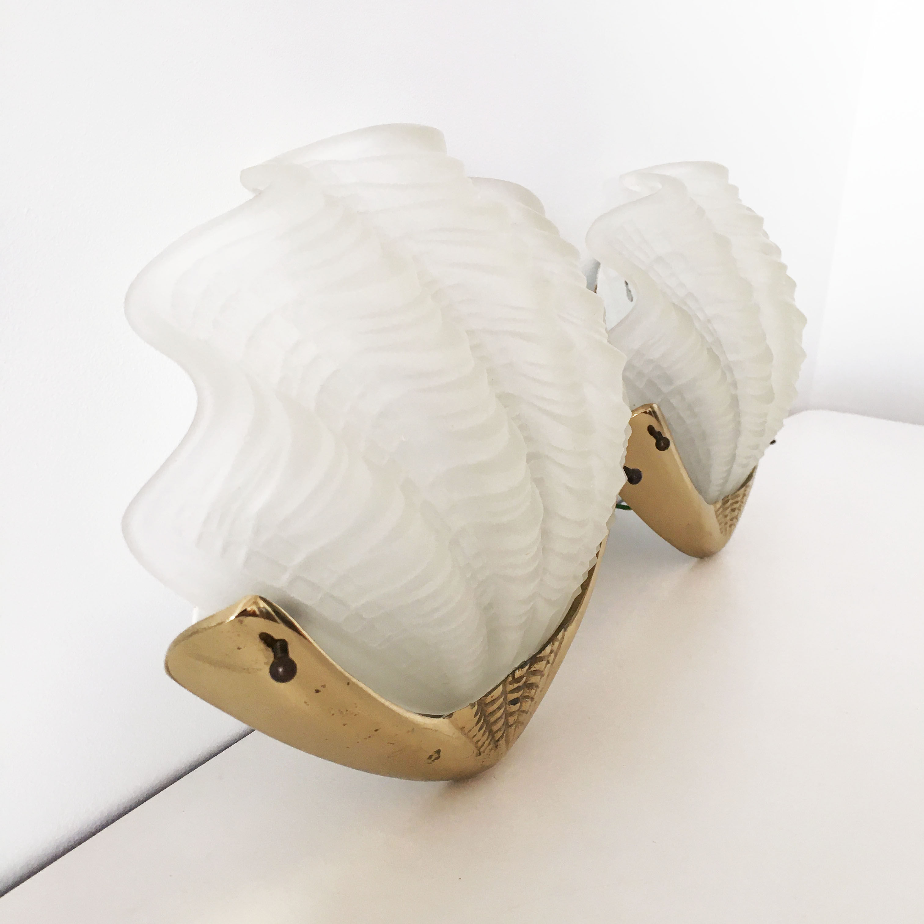 Pair of glass and gold metal shell sconces