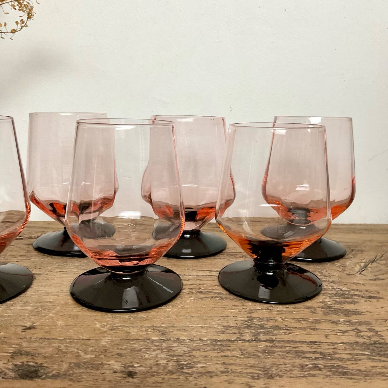 6 small pink glasses with black stem