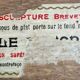 Antique musical trivet made of carved wood and Belle Époque earthenware.