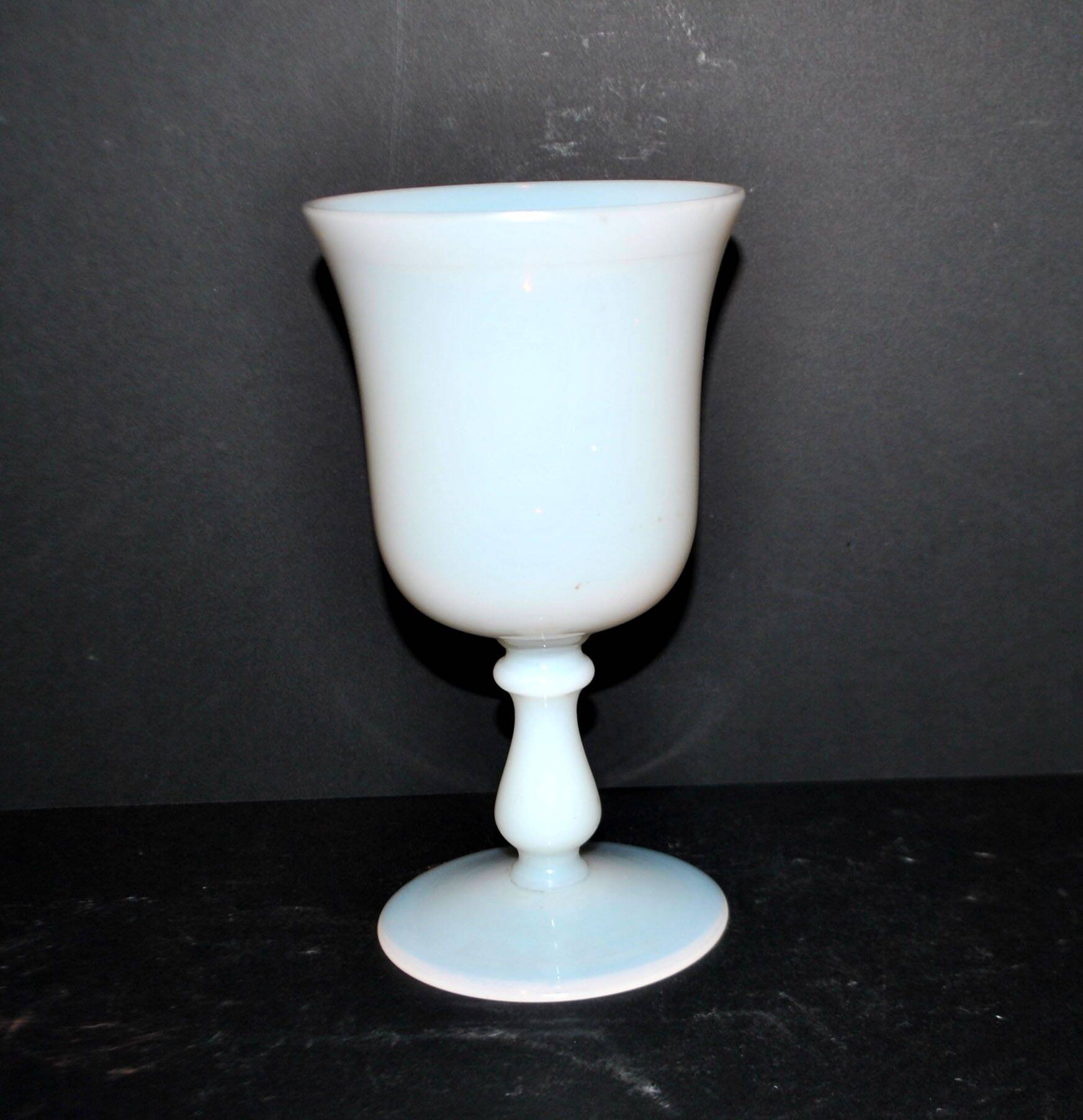 Ancient opaline white glass goblet with a soap bubble effect.