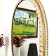 Large oval Florentine mirror in carved wood and gilded with gold leaf.