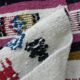 Handmade Berber kilim rug with multicoloured tribal motifs.