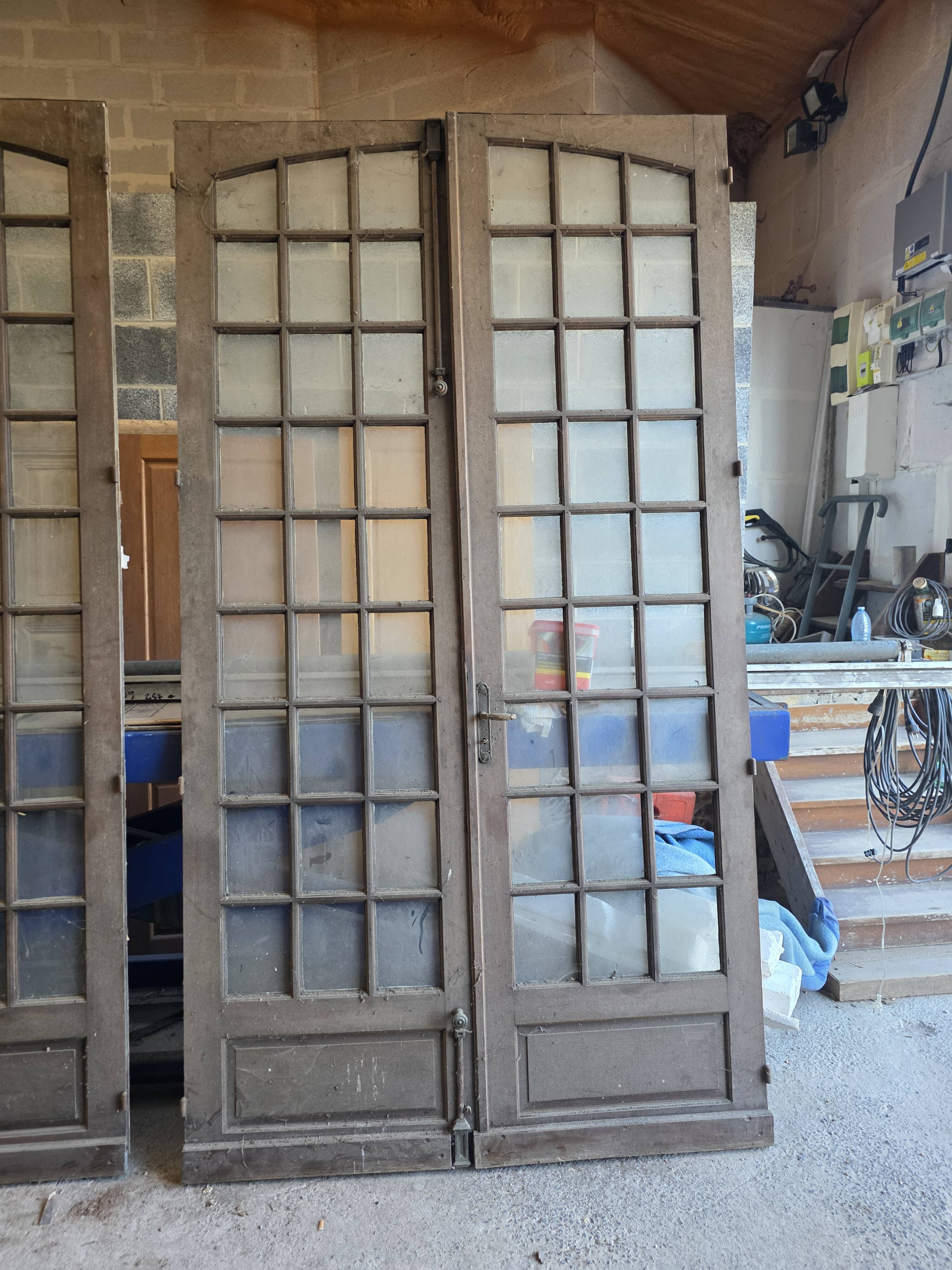 Two pairs of solid oak doors with small panes.