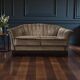 Vintage taupe two-seater canapé with fringes.