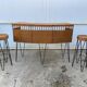 Vintage 1950s bar counter with its two rattan and metal stools.