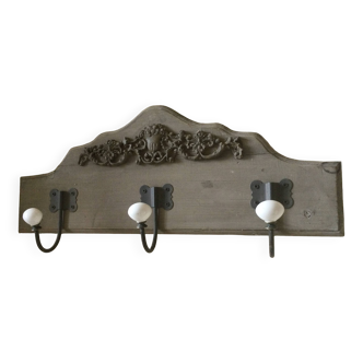 Wall-mounted wooden coat rack with 3 hooks.
