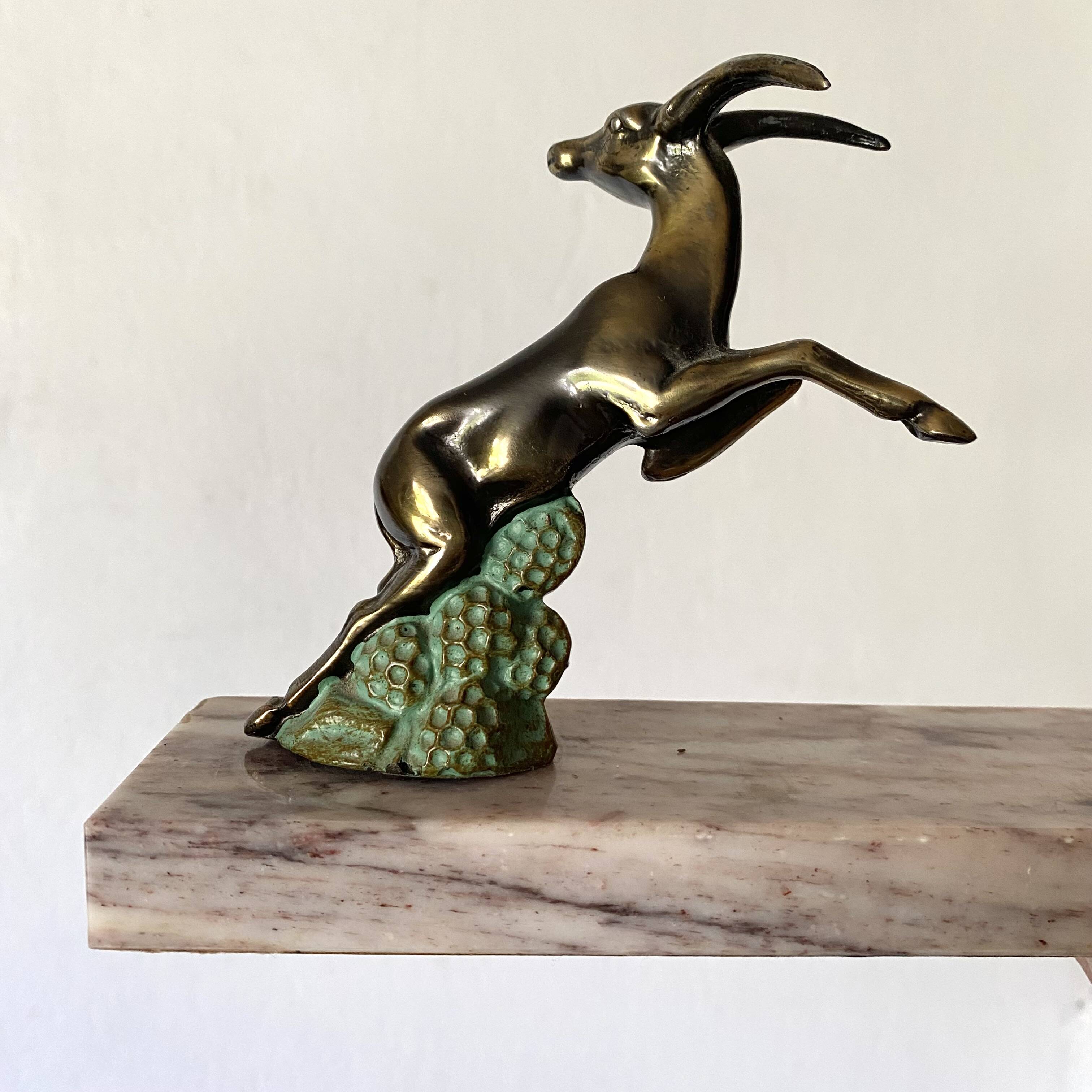Art deco bookends in pink marble and spelters, antelopes