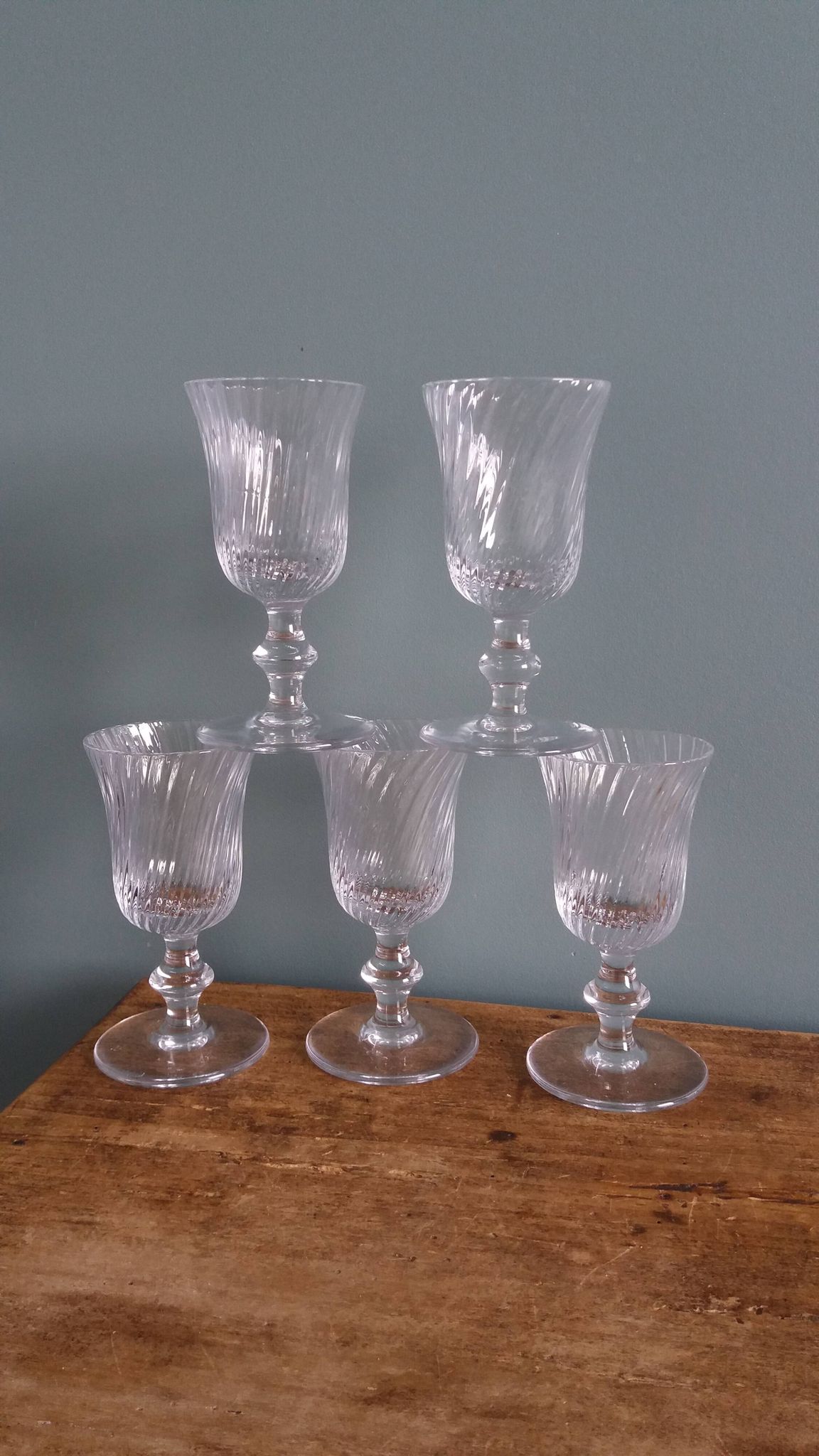 Ancient footed crystal glasses with relief twisted fluted goblets.