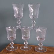 Ancient footed crystal glasses with relief twisted fluted goblets.