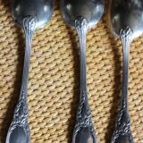 A set of 6 silver-plated metal soup spoons with foliage design.