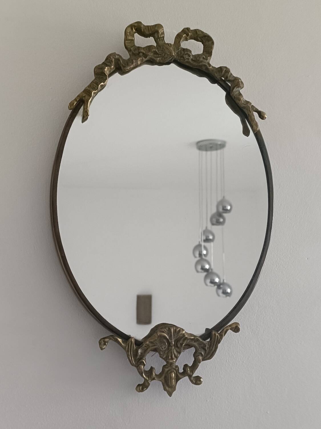 Antique mirror, oval with brass crest