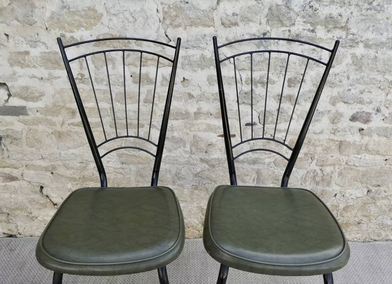 Black metal chairs with khaki faux leather seats, circa 1960.
