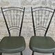 Black metal chairs with khaki faux leather seats, circa 1960.