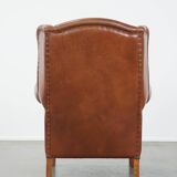 Cognac-colored leather wingback chair in English style