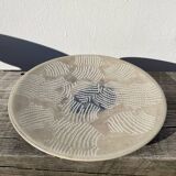 Round ethnic handmade fish dish