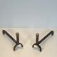 Pair of modernist fire dogs in wrought iron and brass