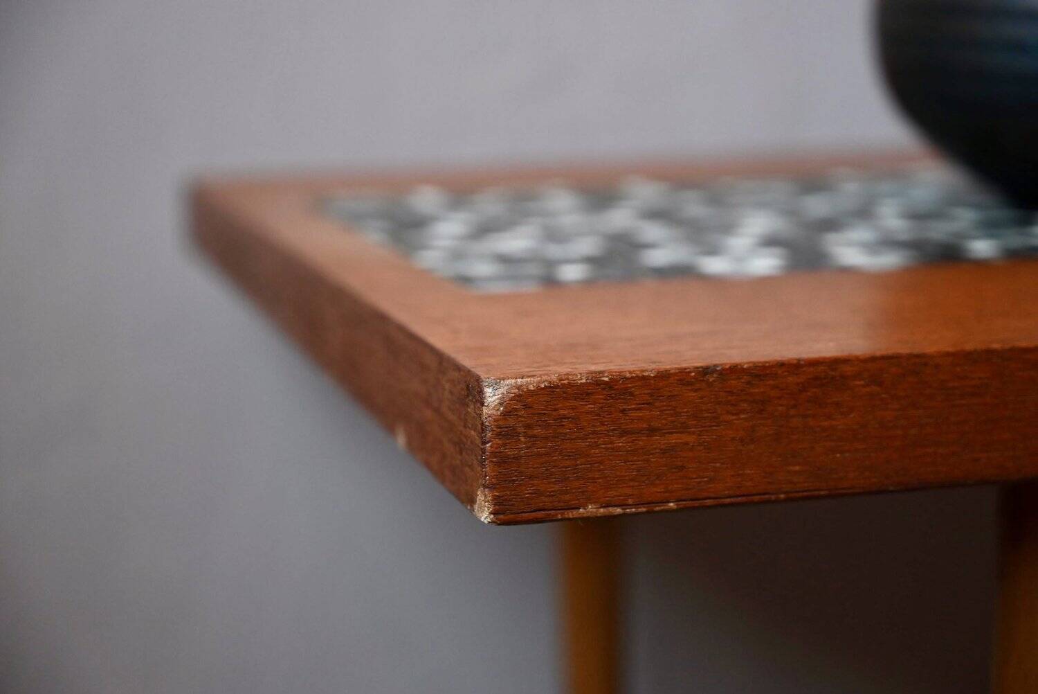 1970s coffee table with a tapered teak base and ceramic mosaic.