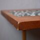 1970s coffee table with a tapered teak base and ceramic mosaic.