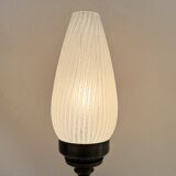 Old bronze or brass table lamp from the early 20th century with white streaked flame glass globe