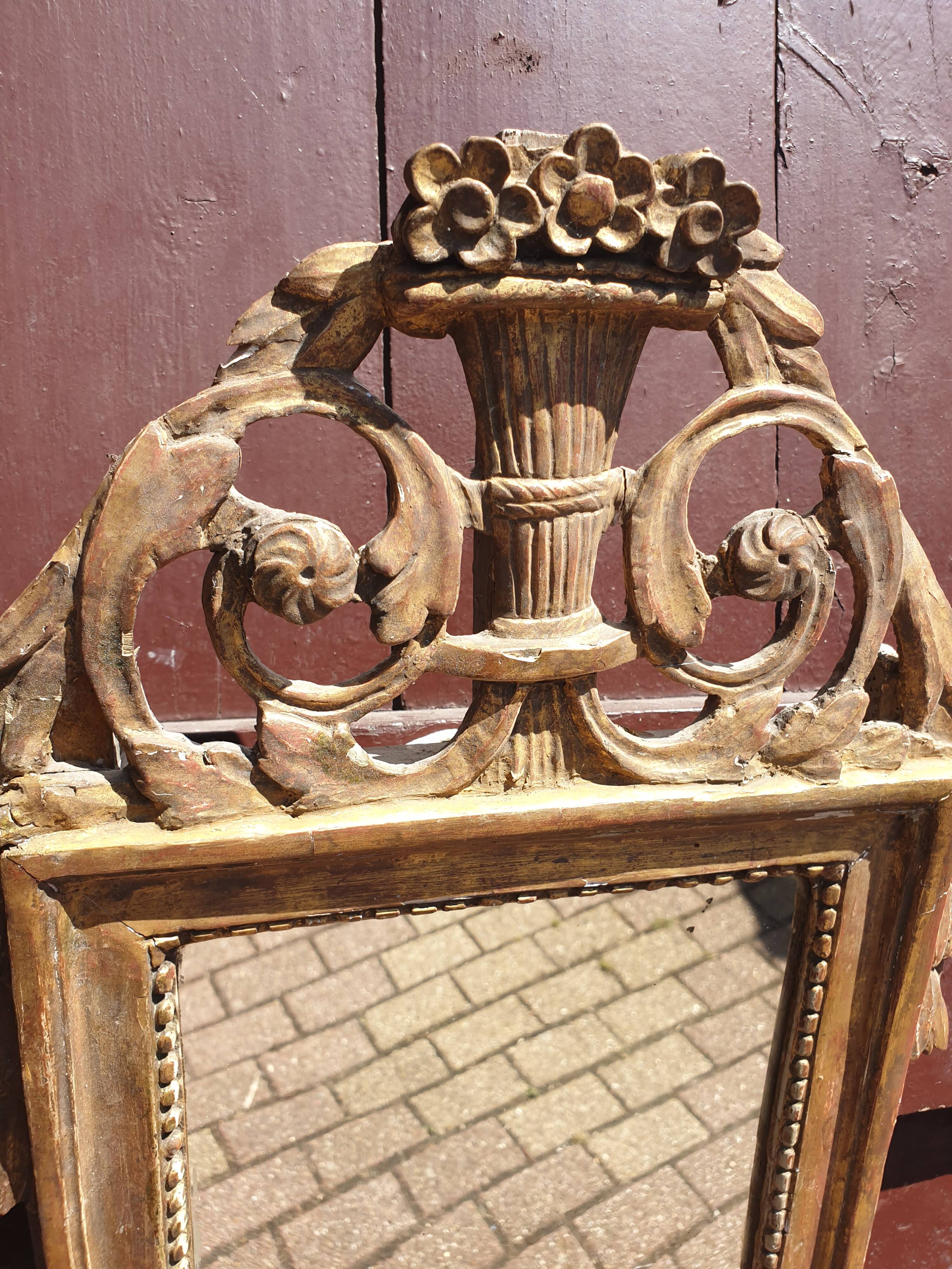 Old mirror in carved and gilded wood