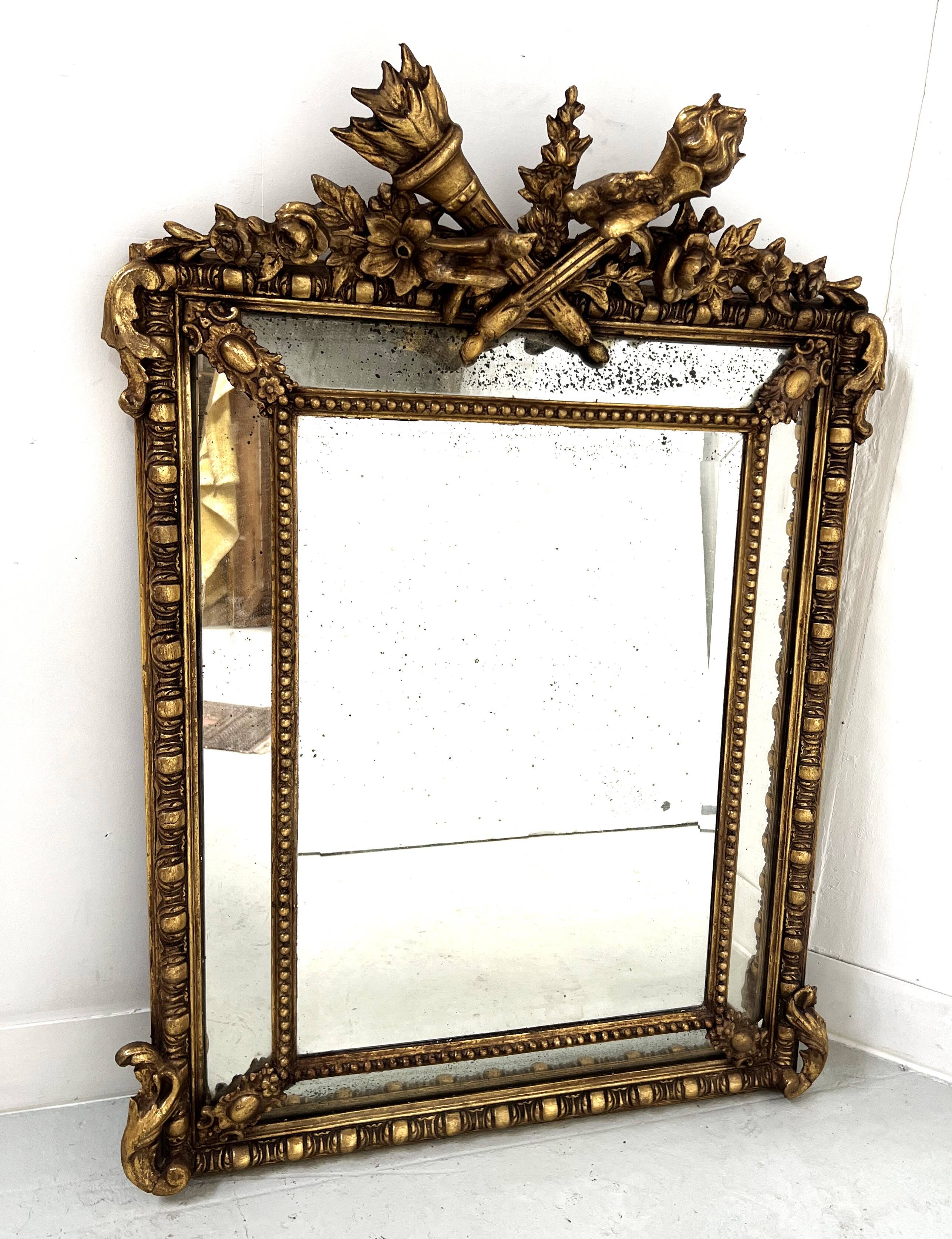 Louis XVI style mirror with parecloses in wood and gilded stucco, 19th century