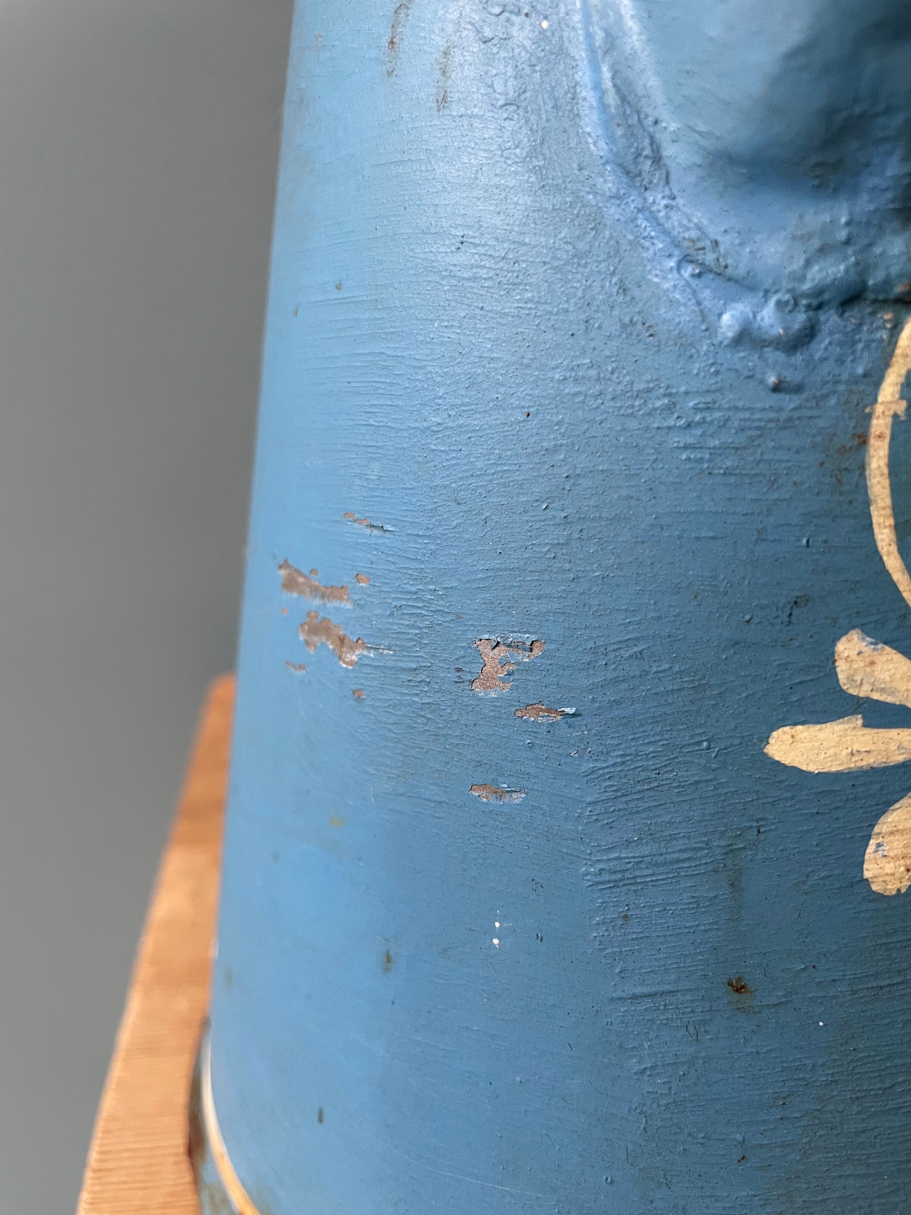 Old painted sheet metal jug or milk jug