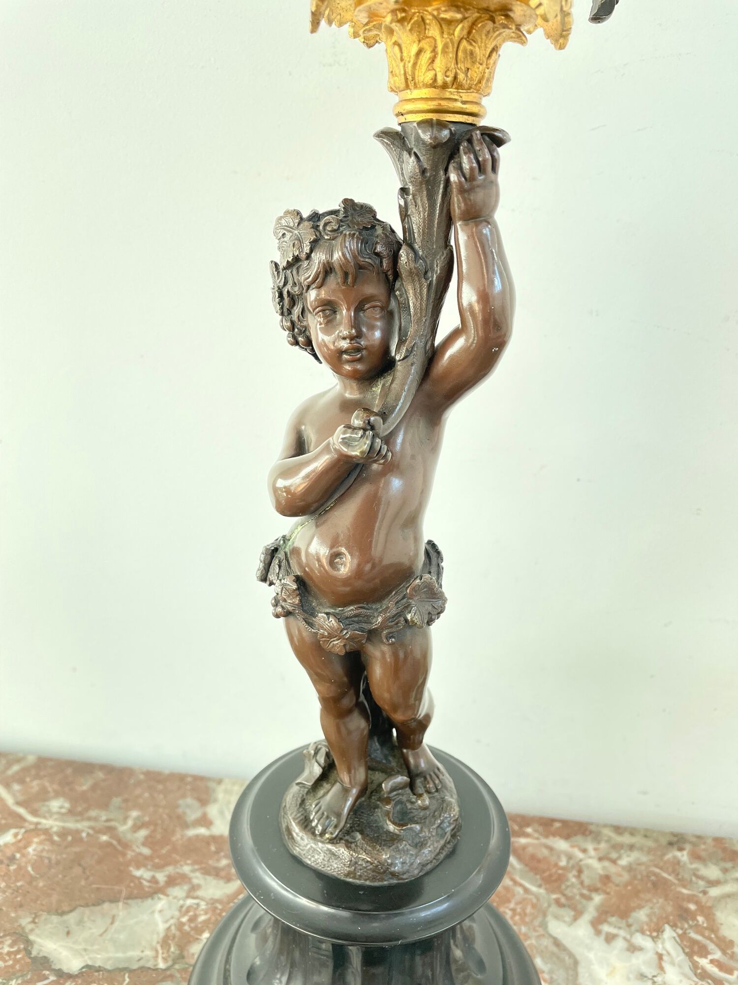 Candelabra with cherub in patinated bronze