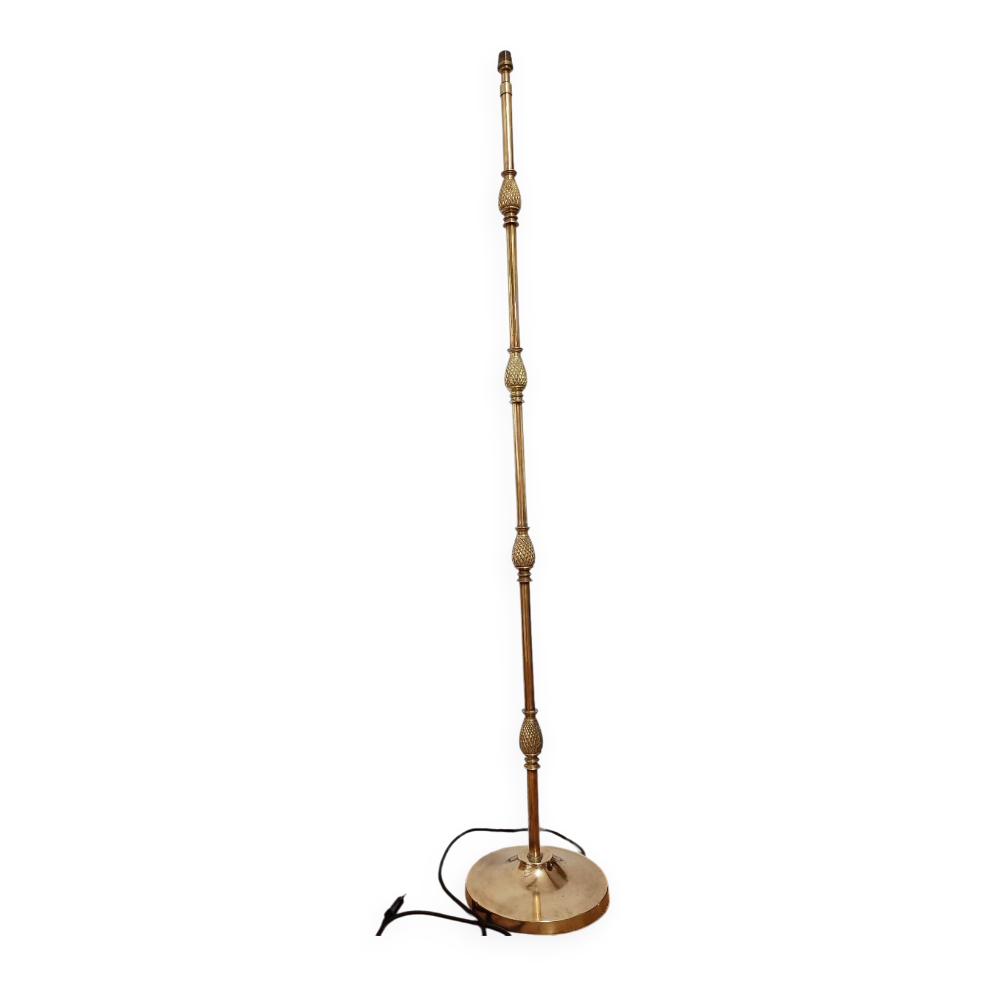 Bronze floor lamp with pine cone decoration.