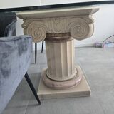 Oval glass table with marble column.