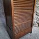 French antique wardrobe with curtain in oak, circa 1920–1930.
