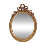Wear consistent with age and use Wood and gilded plaster "Noeud d'Amour" Oval mirror
