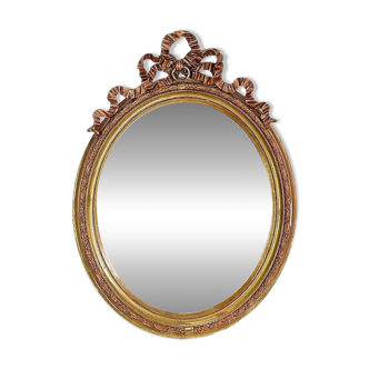 Wear consistent with age and use Wood and gilded plaster "Noeud d'Amour" Oval mirror