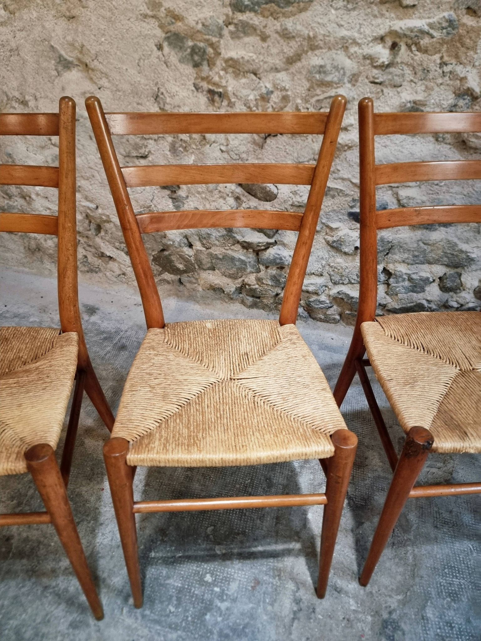 Set of 4 mid-century Italian dining chairs with woven seats, circa 1950–1970.