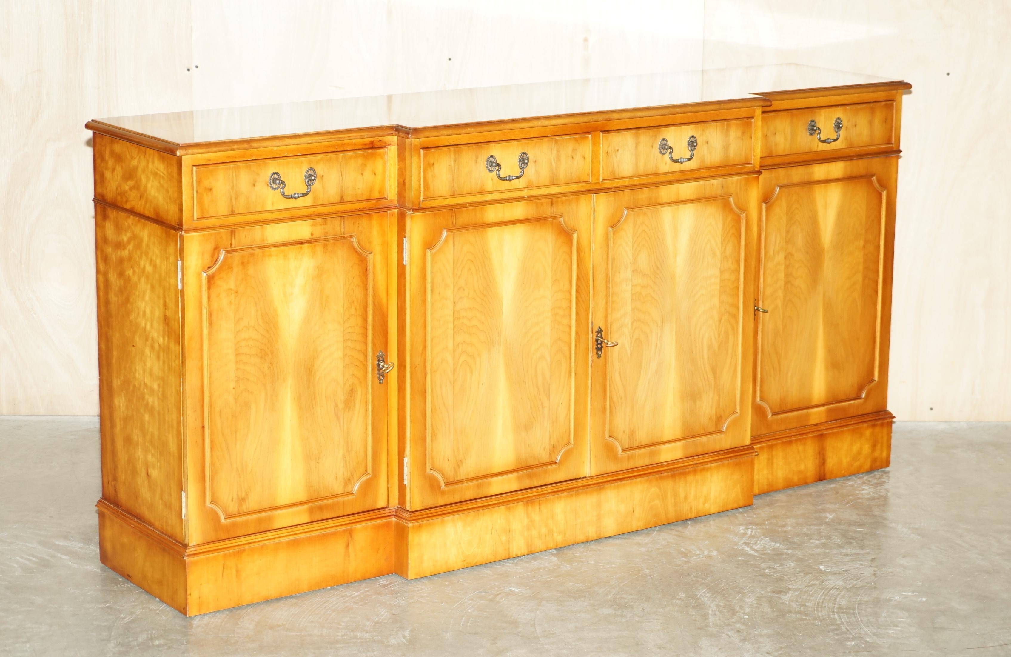 Vintage buffet made of mottled yew wood with three doors and four drawers.