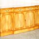 Vintage buffet made of mottled yew wood with three doors and four drawers.