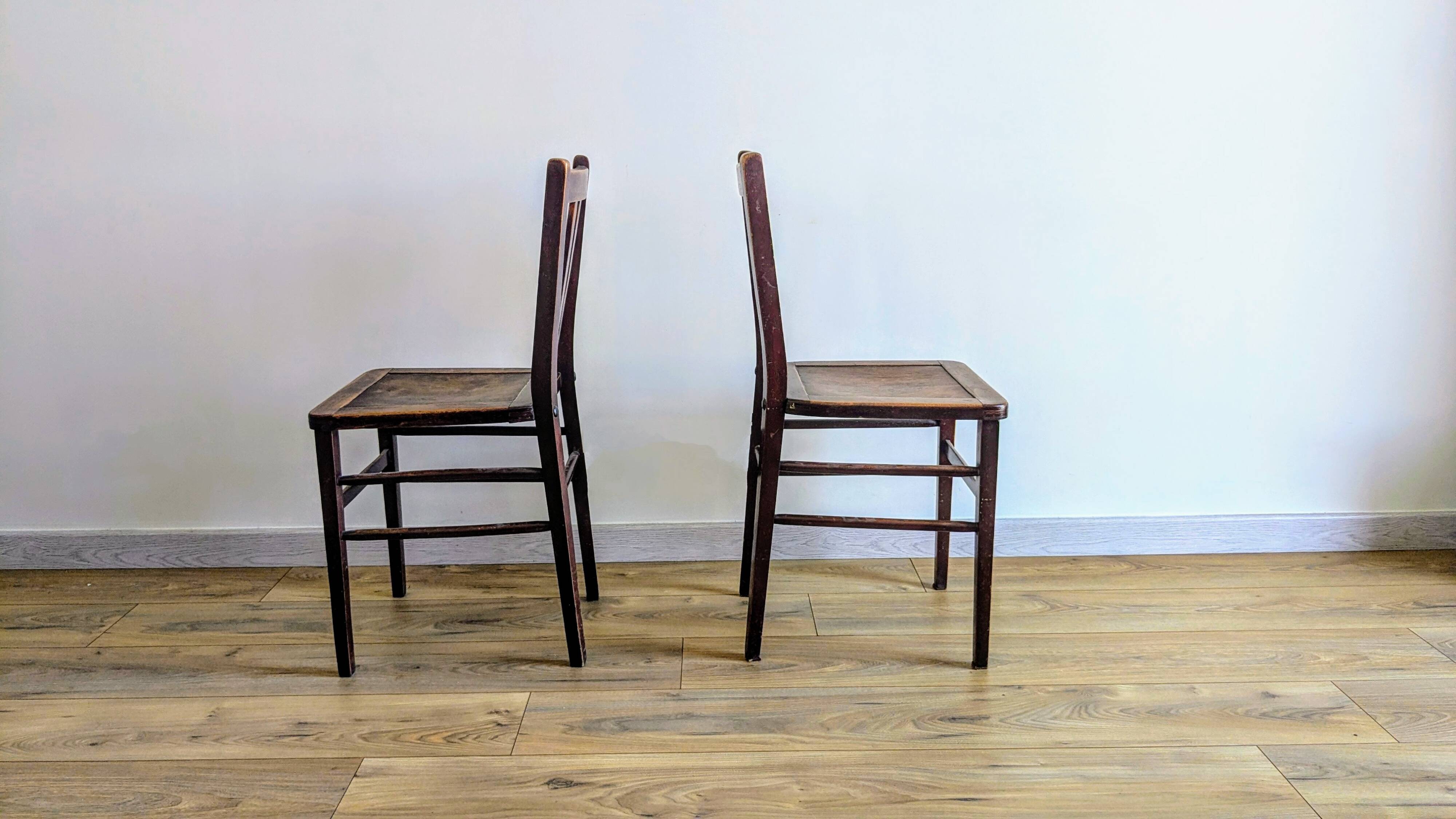 Pair of 1930s bistro chairs with patinated wood.
