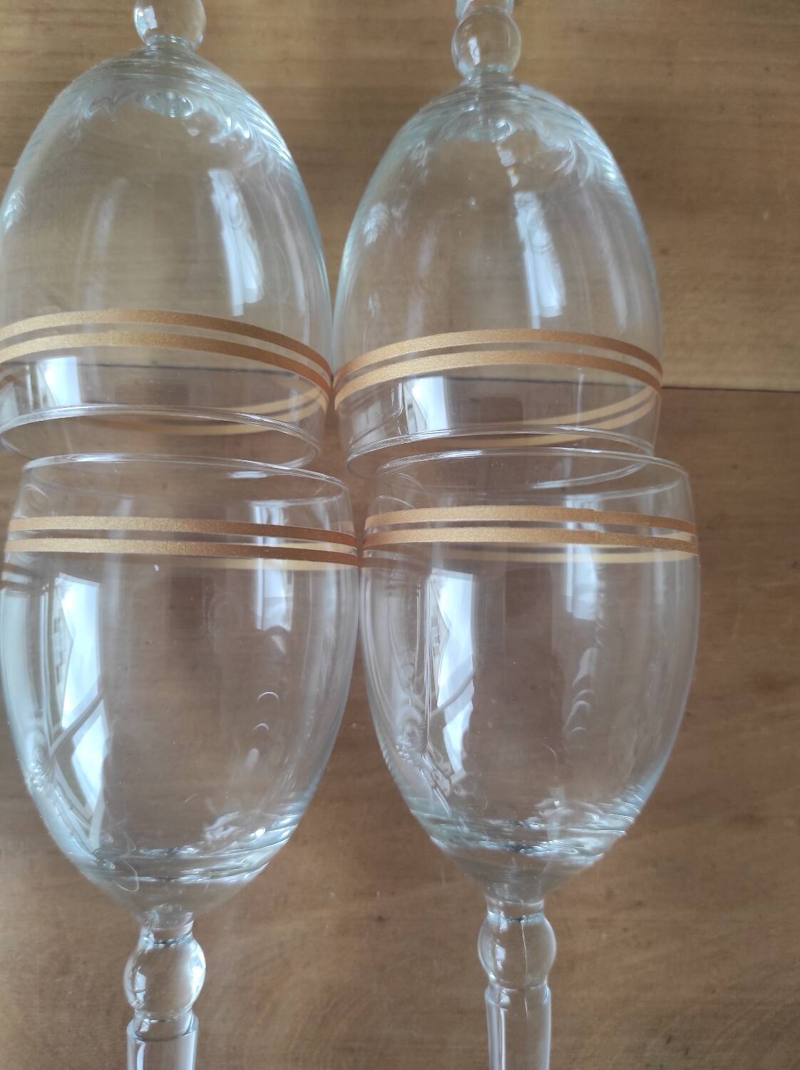 Set of 6 glasses with gold band decorations.