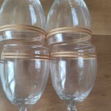 Set of 6 glasses with gold band decorations.