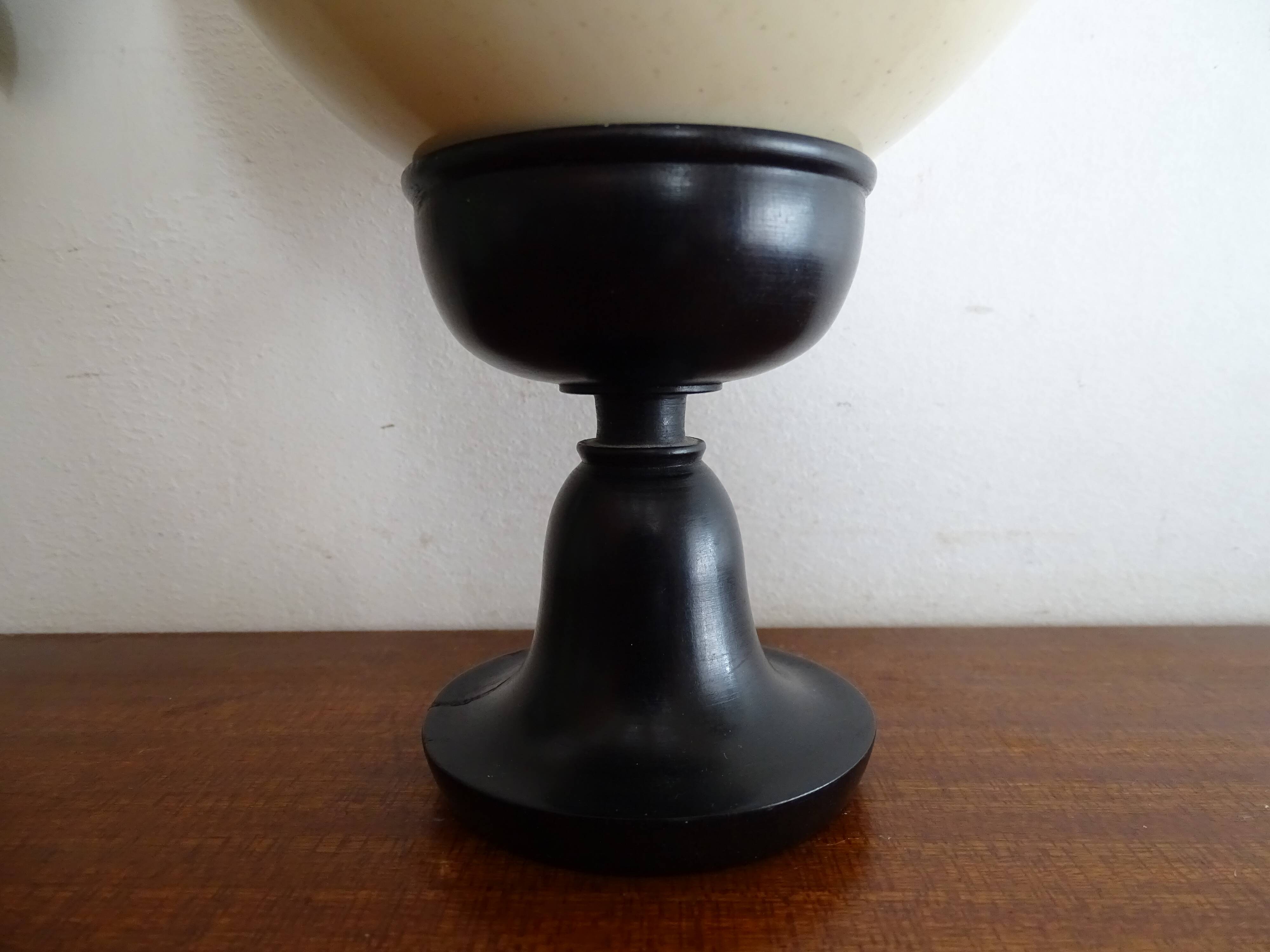 Ostrich egg on blackened wooden base - object of curiosity