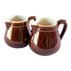 Duo of brown enamel pitchers