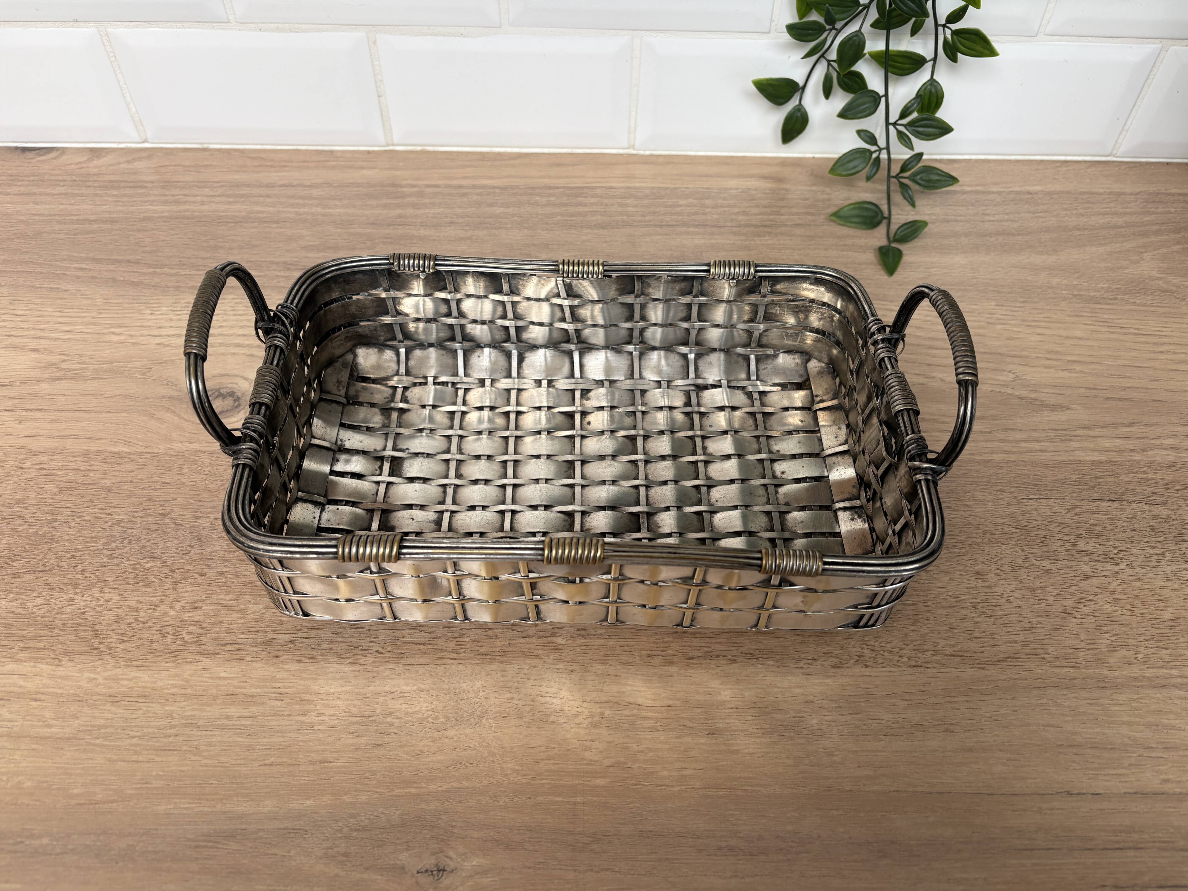 Woven silver-plated metal basket.