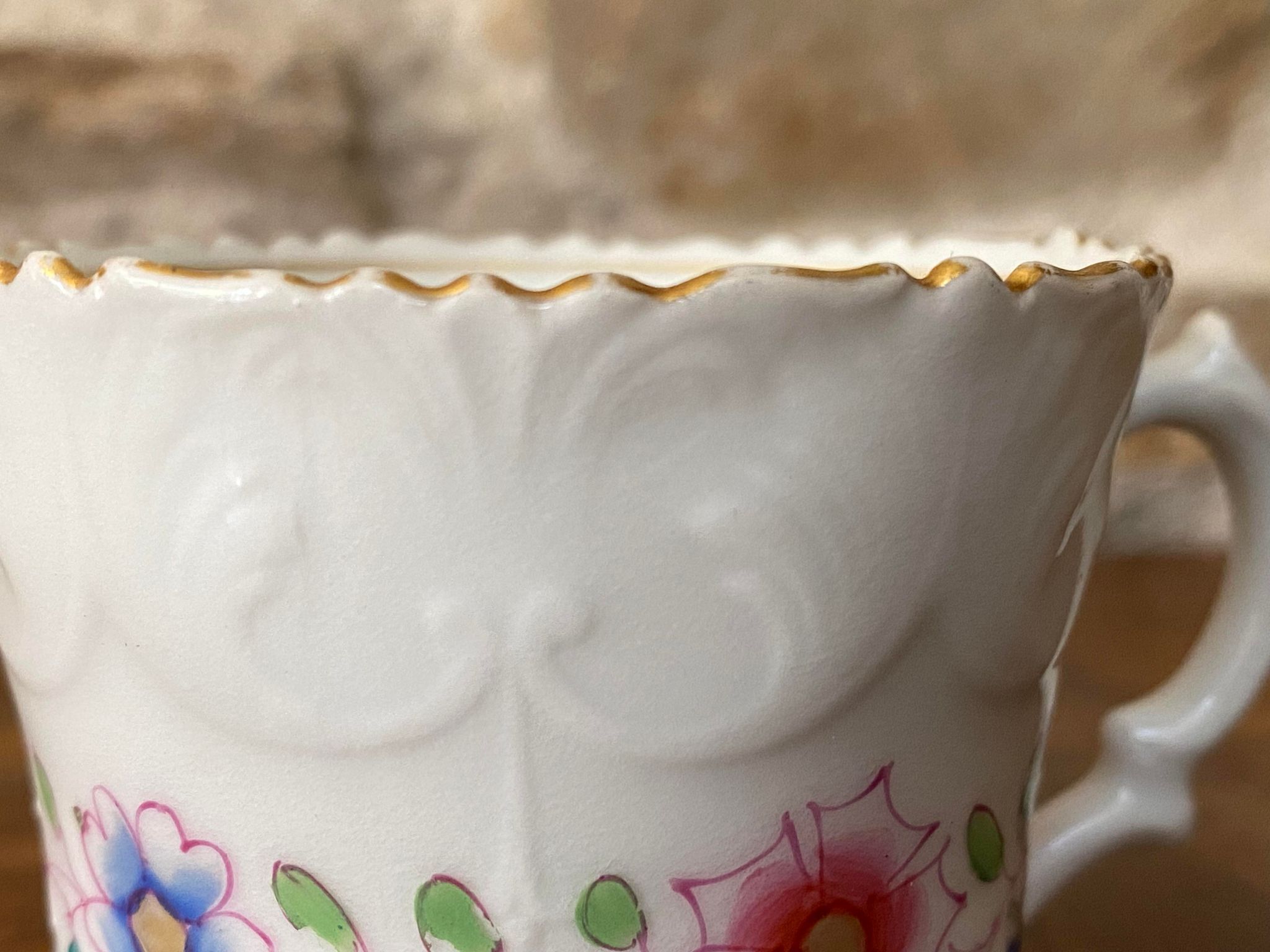 Porcelain cup with chiseled and gilded rim