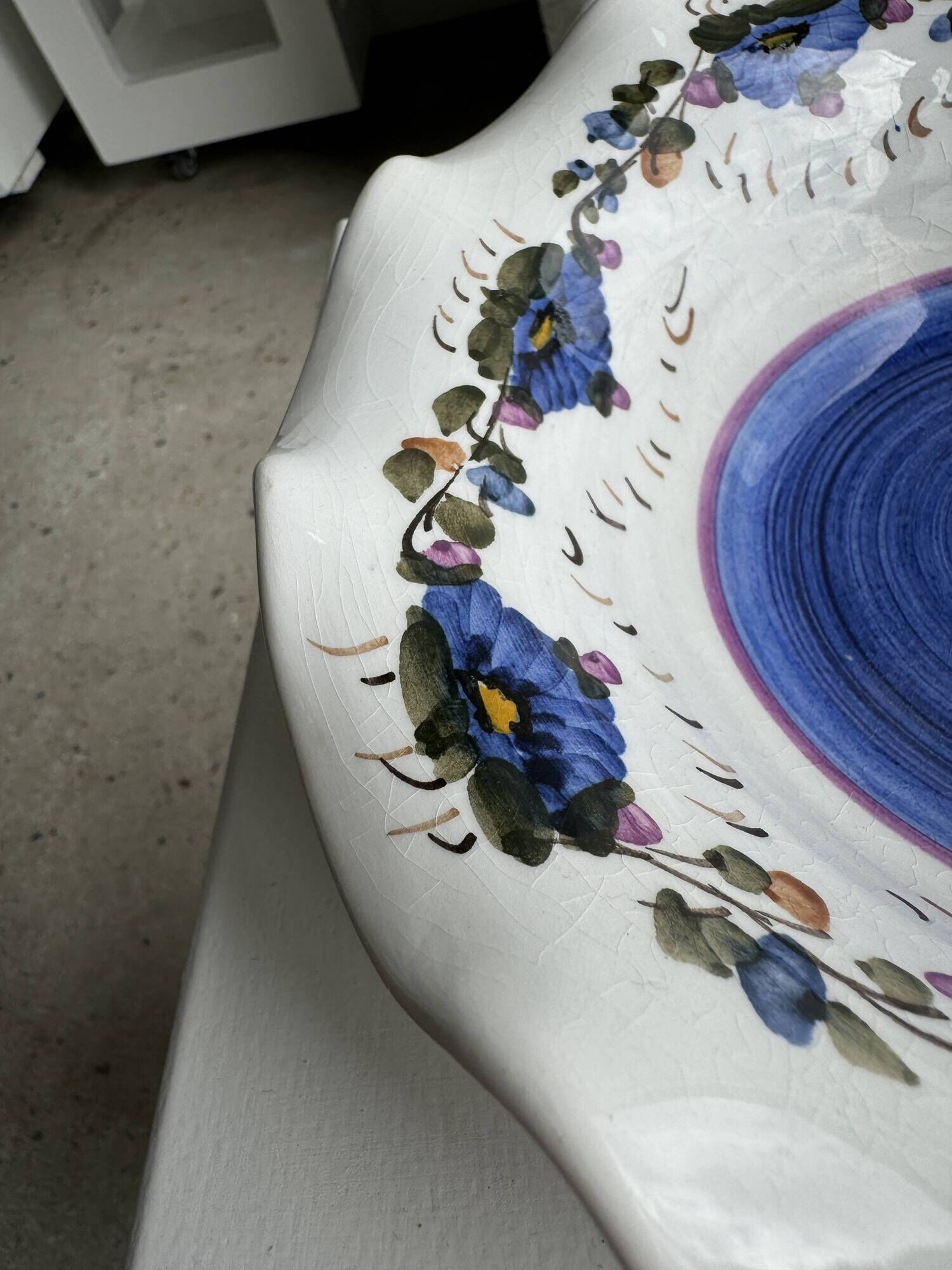 Small hand-painted earthenware salad bowl with garland of blue flowers, mark below
