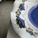 Small hand-painted earthenware salad bowl with garland of blue flowers, mark below