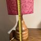 Vintage lamp with a carved wooden base from the 1970s.